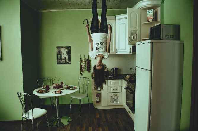 girl upside down in kitchen